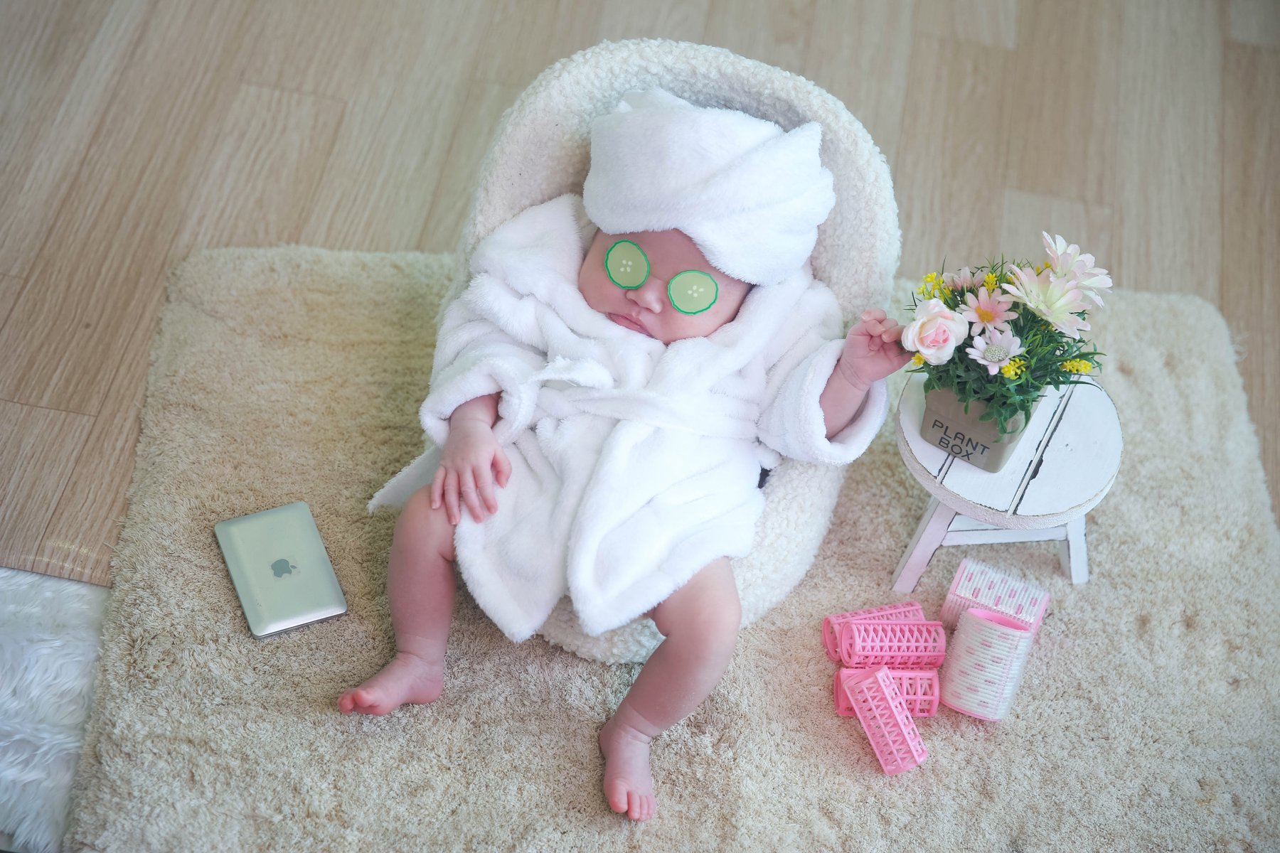 Newborn in a spa robe with cucumber eyes